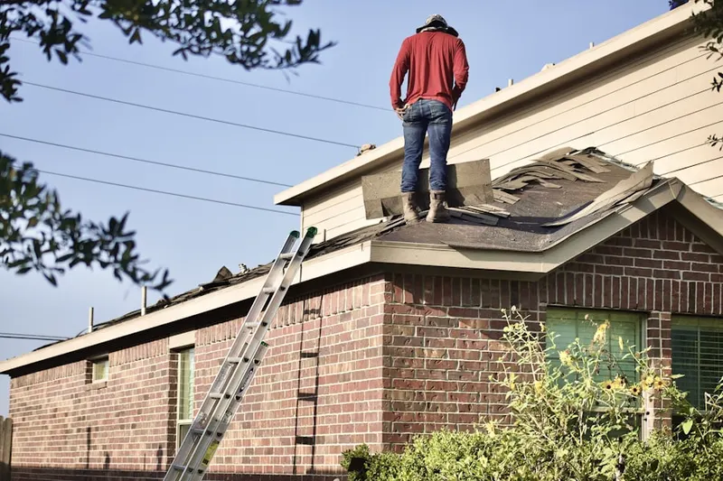 Professional roofer working on a residential roof in Montana Vista
